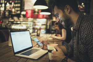 Man using smart phone in cafe