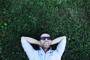 man laying on the grass with sunglasses 2