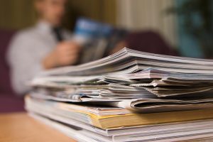 A man in a waiting room reading magazines