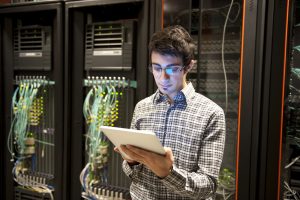 man holding a computer diagnosing server issues