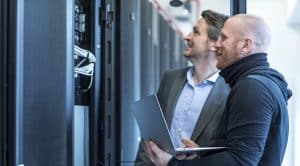 two men assessing a server in the office